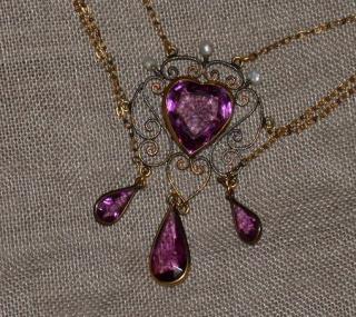Central amethyst heart above three pear shape pendant drops