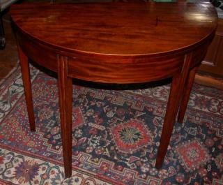 This view shows the mahogany's vivid grain, and a hint of serpentine molded profile on legs