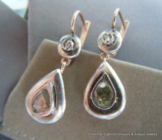 Each pear shape pendant set with one large rose cut diamond