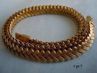 The woven gold choker is supple and flexible