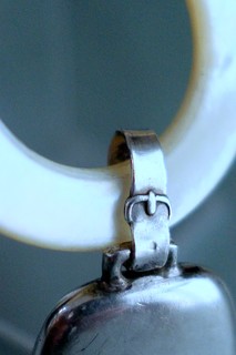 Buckle motif connects bell and teething ring