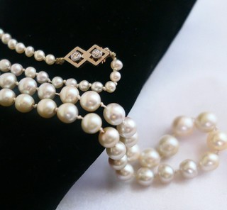 NATURAL SALTWATER PEARLS STRAND, 21", graduated from 7.8mm diameter, twin diamond Art Deco clasp