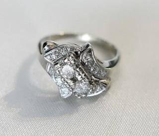 "DIAGONAL CENTER, RIBBON CURLS" twelve diamonds ring