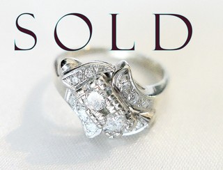"DIAGONAL CENTER, RIBBON CURLS" twelve diamonds ring