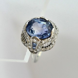 CEYLON SAPPHIRE (5 carats) Edwardian Platinum Ring with fifty-six diamonds and four calibre cut accent sapphires