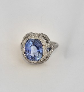 CEYLON SAPPHIRE (5 carats) Edwardian Platinum Ring with fifty-six diamonds and four calibre cut accent sapphires