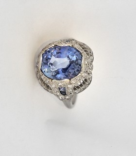 CEYLON SAPPHIRE (5 carats) Edwardian Platinum Ring with fifty-six diamonds and four calibre cut accent sapphires