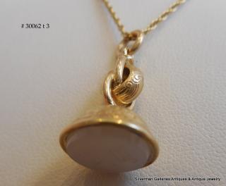 The engraved gem is Milky Chalcedony, a white agate