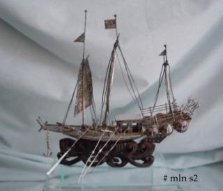 The silver ship is 6-1/4" long and 4-1/2" tall